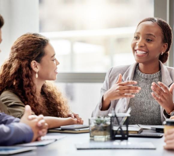 woman explaining something to group of men and women