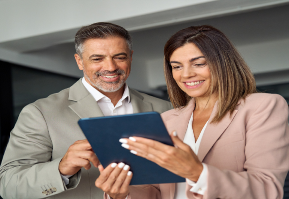 two people reading a tablet