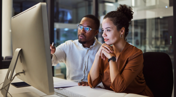 Two people looking at a plan