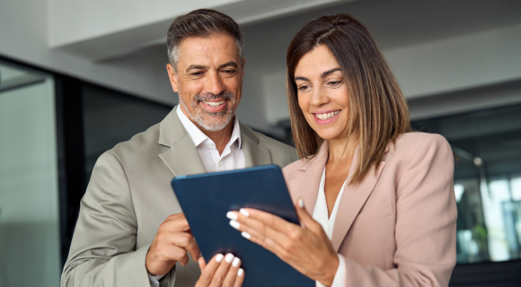 two people reading a tablet